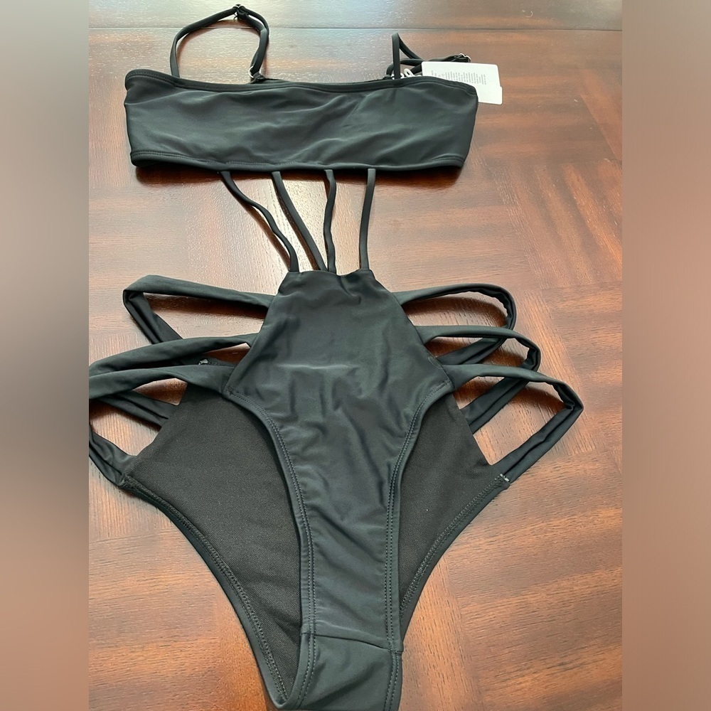 Brazilian women’s one piece black swimsuit size medium.